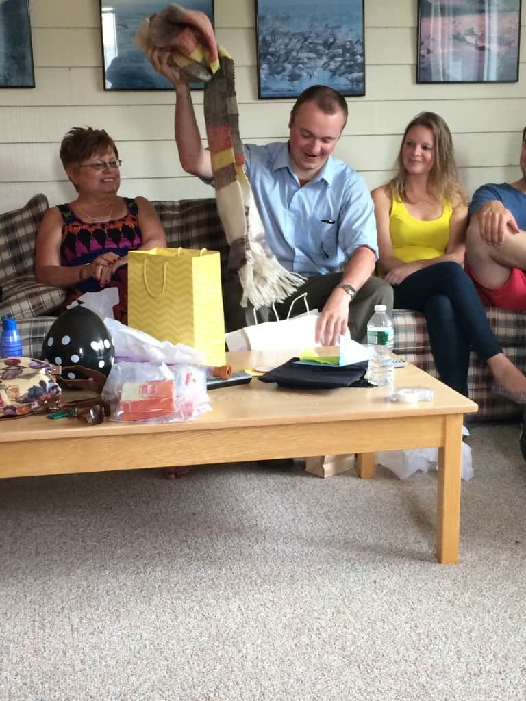 Cooper opening the scarf while my mother (l) and cousin (Cooper's sister) (r) watch.