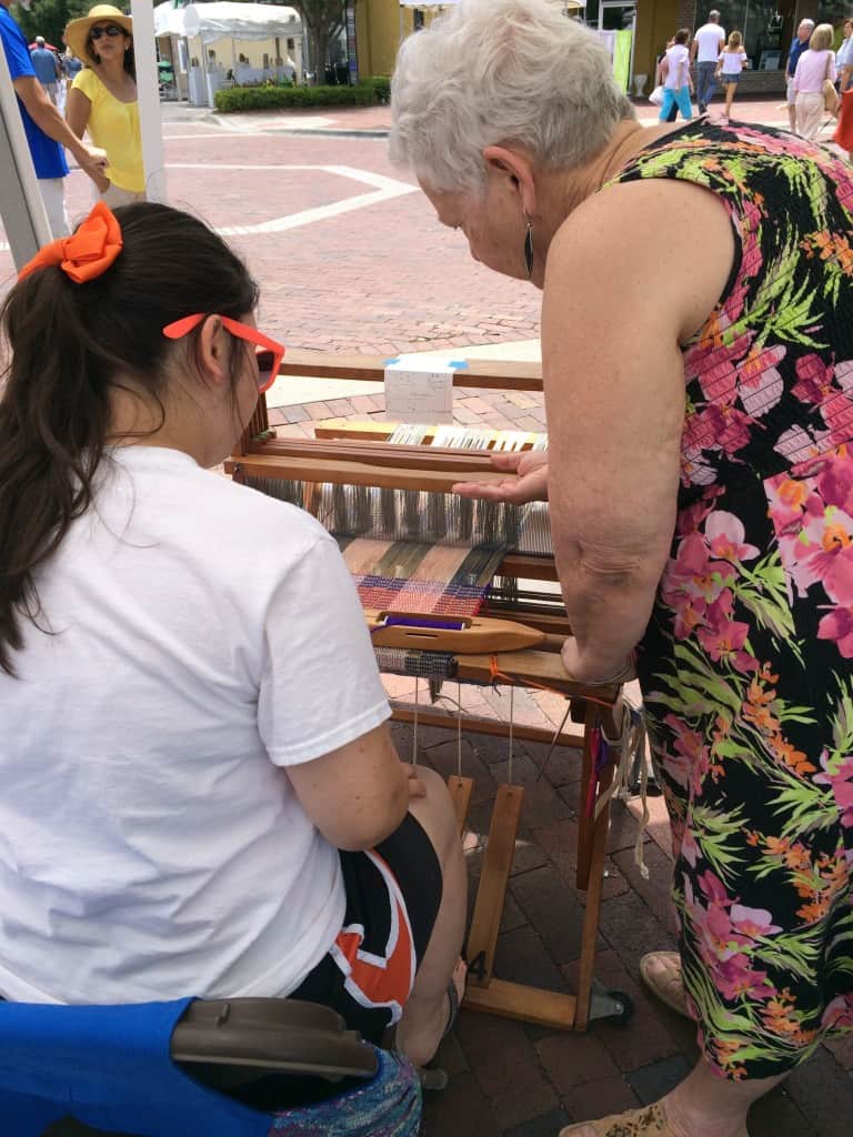 WoO member Marilyn encouraging a first-time weaver.